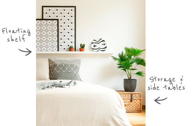 white bedroom with a white floating shelf containing a few decorative items